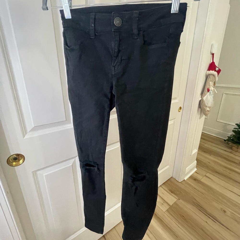Black skinny jeans with holes on the knees, not very worn